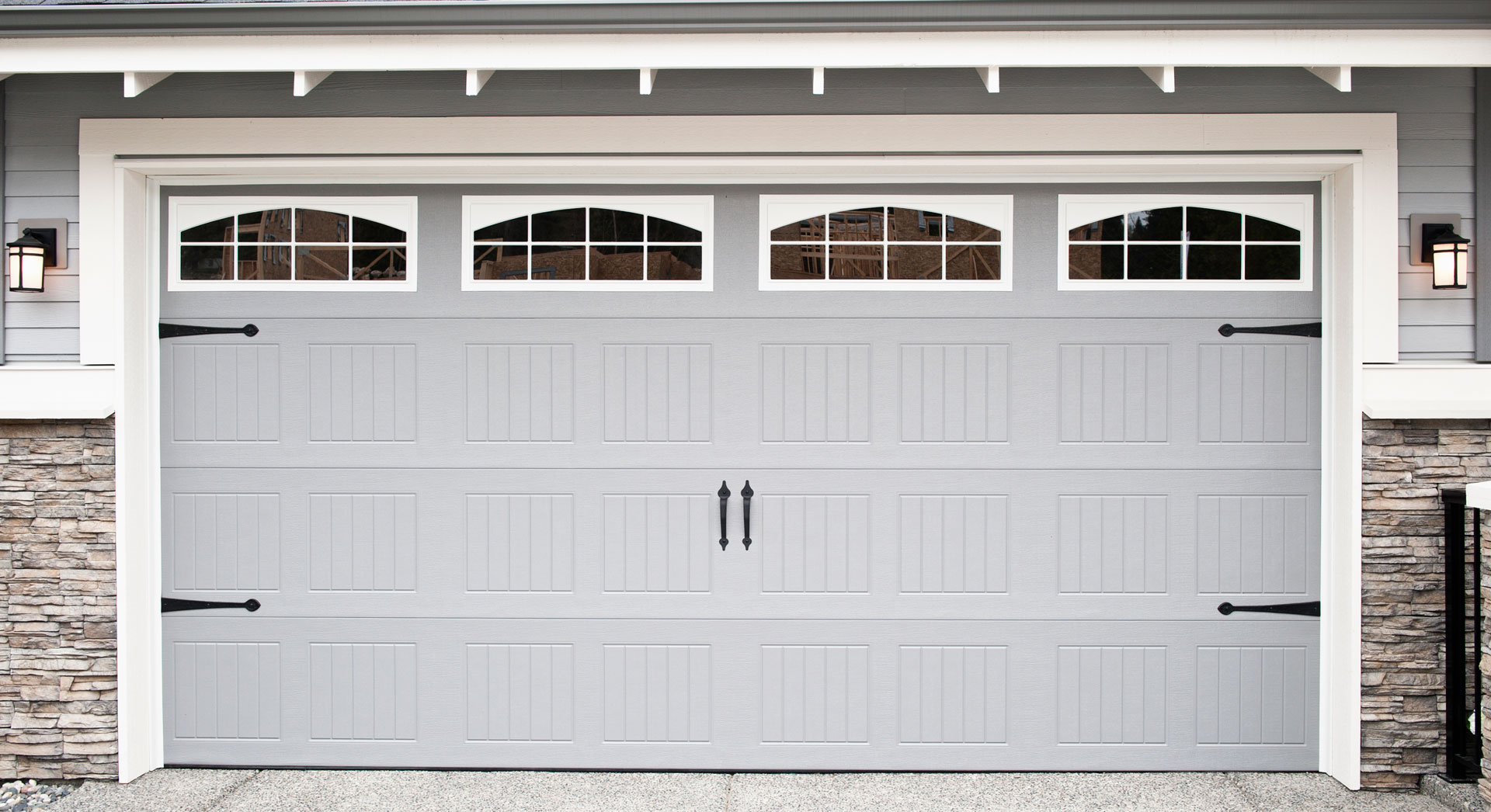 Gray attached garage door with four rectangular glass windows